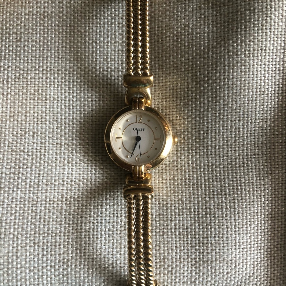 GUESS gold tone petite watch.